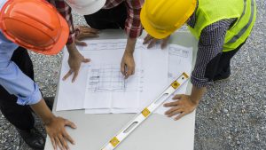 Construction workers looking at blueprints.